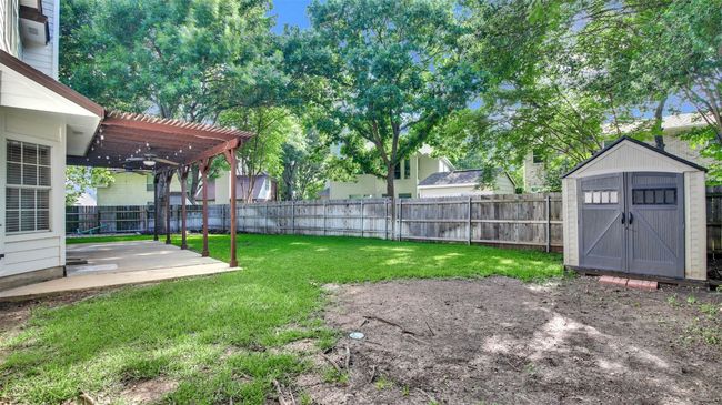 View of yard featuring a patio area, a pergola, and a ceiling fan | Image 24