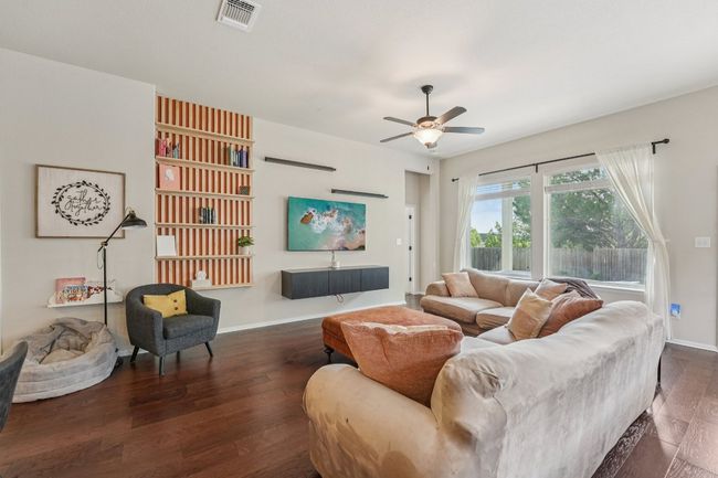 Large yet cozy living room with custom accents, high ceilings, ceiling fan | Image 5