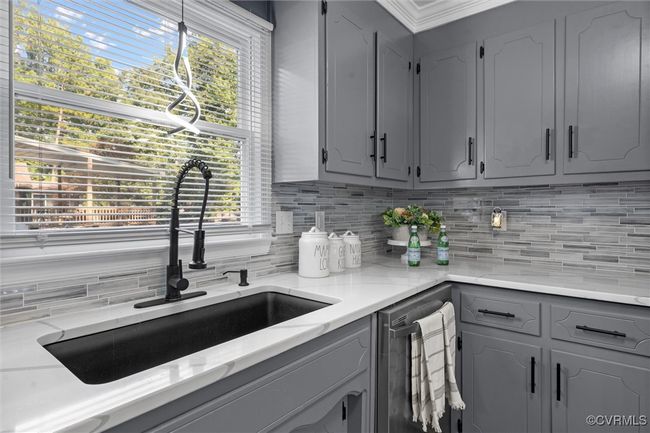 Kitchen with gray cabinetry, tasteful backsplash, plenty of natural light, and dishwasher | Image 16