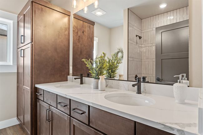 Bathroom with double vanity, wood finished floors, tiled shower, and recessed lighting | Image 47