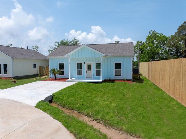 Charming single-story home with a fresh blue exterior and white trim. Features a small front porch, a neat driveway, and a spacious fenced yard. Ideal for cozy living with modern appeal. | Image 22