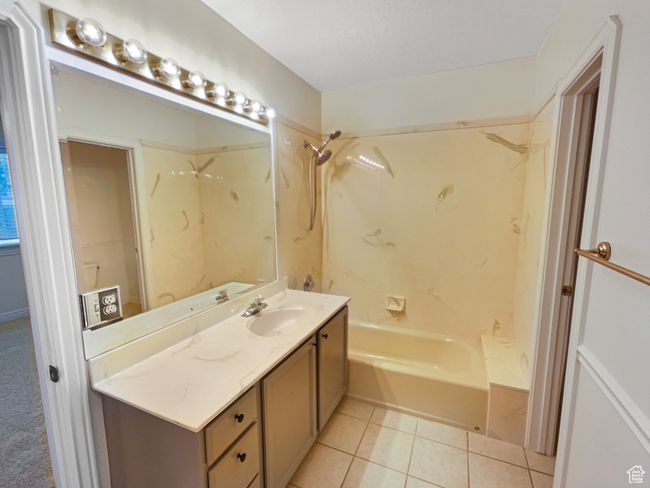 Bathroom featuring tile patterned flooring, vanity, and shower combination | Image 15