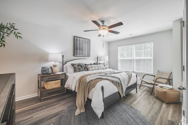 Bedroom with wood finished floors and a ceiling fan | Image 10