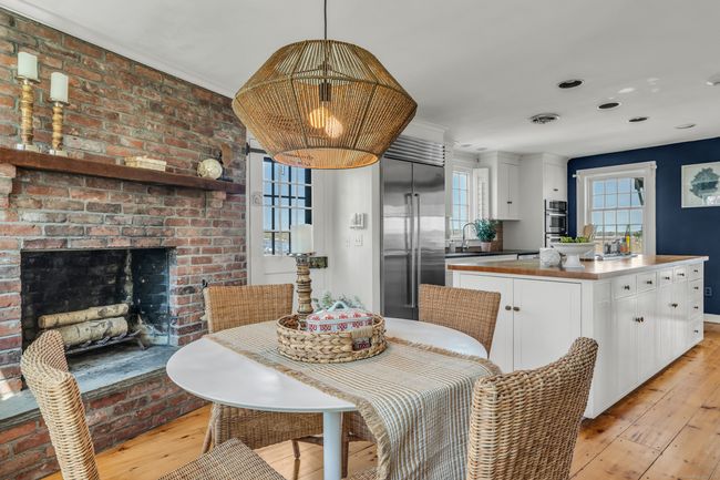 The Beautifully Remodeled Chef's Kitchen With A Casual Dining Area Is Centered Around The Fireplace | Image 11