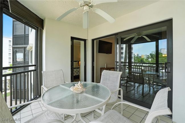 Balcony featuring ceiling fan and outdoor dining space | Image 31