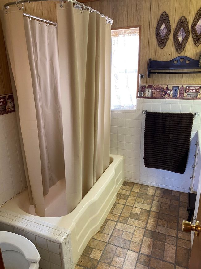 Bathroom featuring tile walls | Image 18