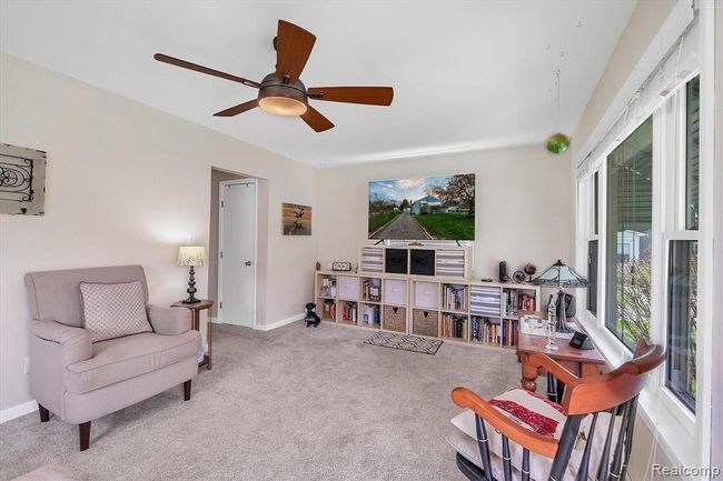 View of living room with tons of natural light and ceiling fan | Image 7