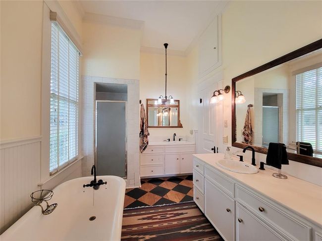 Sleek walk-in shower complemented by a spacious vanity. | Image 20