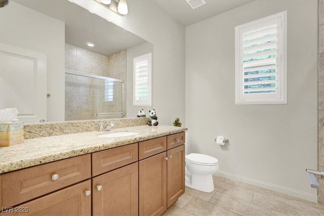 Bathroom featuring vanity, a shower stall, and tile patterned floors | Image 31