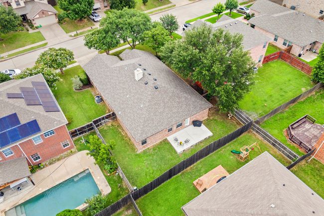 Side angle of the backyard showing the privacy fence and generous grassy area. | Image 35