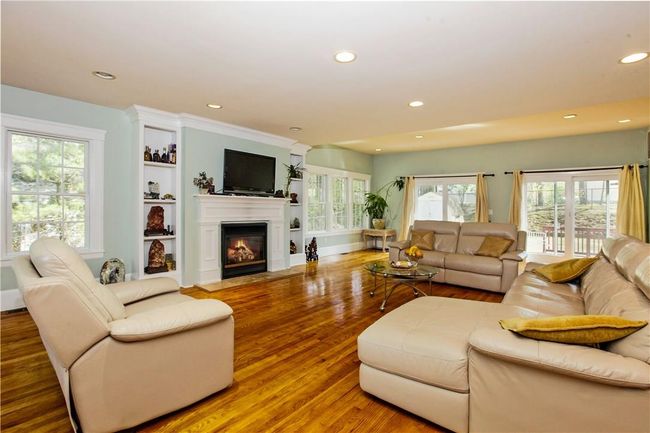 Spacious family room with fireplace, built in shelving and sliding doors to the deck and yard. | Image 5