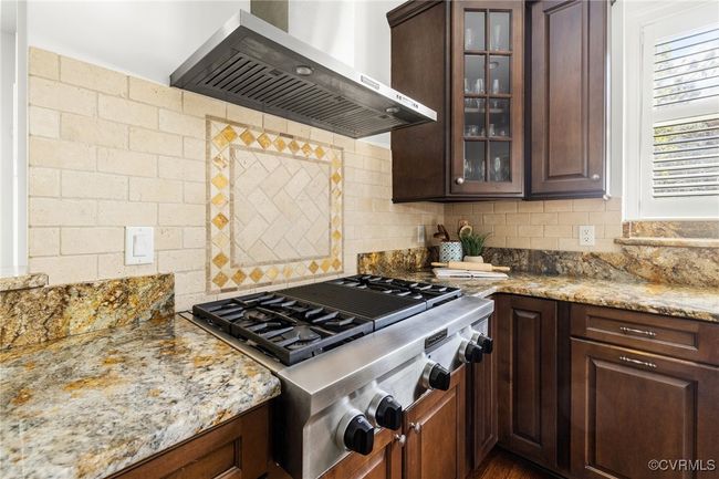10' Ceilings, Surround sound, Island with storage, Kitchen Aid 5 burner gas range, Kitchen aid wall oven, Whirpool wall microwave, Kitchen aid stainless steel refrigerator and dishwasher, Granite countertops, Recessed and pendant lighting, Double bowl stainless sink, corner pantry, decorative tile behind the range, tile backsplash, bar seating. | Image 10