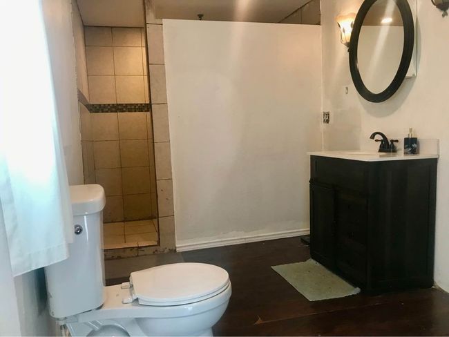 Bathroom with toilet, vanity, and walk in shower | Image 11