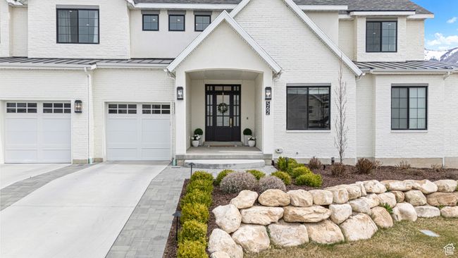 View of front of house featuring concrete driveway, a standing seam roof, and metal roof | Image 4