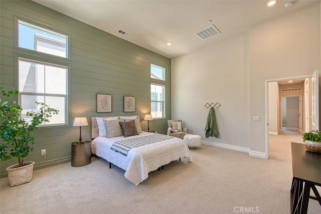Bright and spacious primary bedroom with high ceilings, shiplap accents and en-suite bathroom. | Image 15