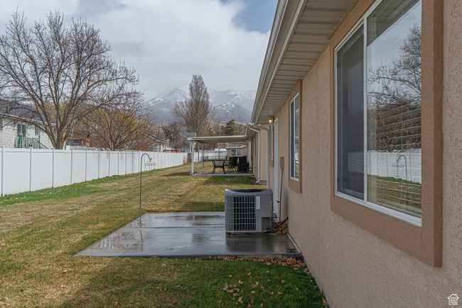 View of yard featuring a mountain view, cooling unit, fence, and a patio area | Image 30
