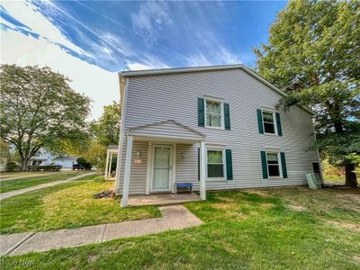 View of front of home with a front lawn and porch | Image 1