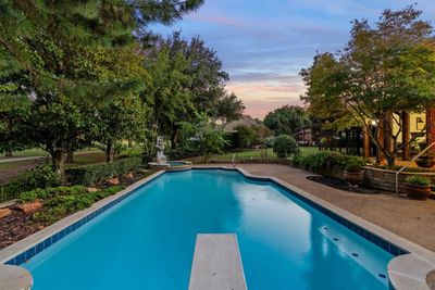 Pool at dusk with a diving board | Image 3