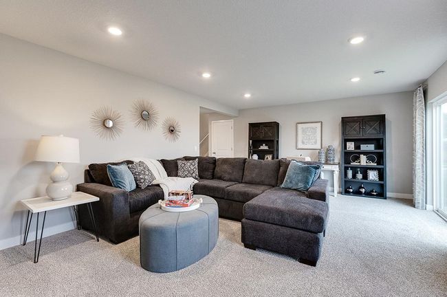 All of that living space up - plus this INCLUDED FINISHED lower level which features an over-sized bedroom with a walk-in closet, another full bathroom plus a giant family room! Photo of model, colors and options will vary. | Image 19