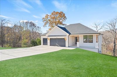 View of front of house featuring a garage and a front lawn | Image 2