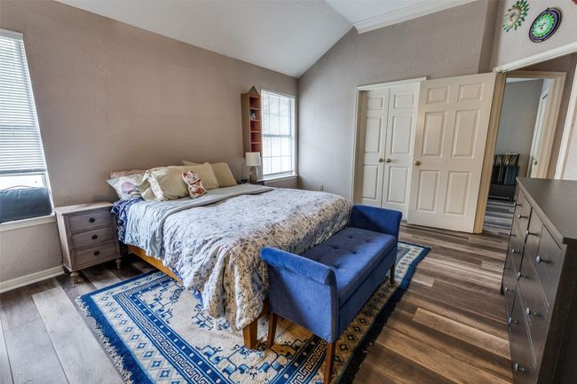 Bedroom featuring baseboards, multiple windows, dark wood-style flooring, and lofted ceiling | Image 23