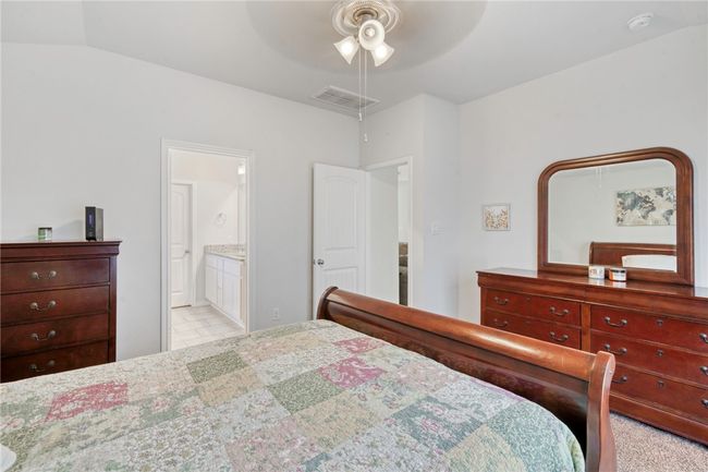 Bedroom with ceiling fan, ensuite bath, and lofted ceiling | Image 19