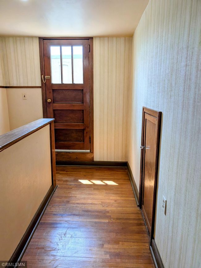 Upstairs hallway. Kneel wall storage. Door leading out to the balcony | Image 32