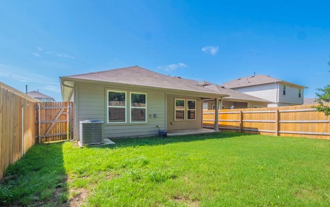 Rear view of house featuring a fenced backyard and a patio | Image 24