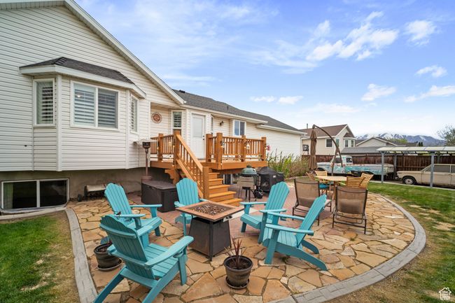 View of patio featuring a deck and a fire pit | Image 30