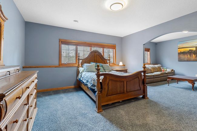 Lower-level first bedroom suite open to separate sitting area and full en-suite bathroom and walk-in closet. View toward backyard and koi pond. | Image 49