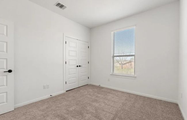 Unfurnished bedroom featuring carpet floors, baseboards, and a closet | Image 10