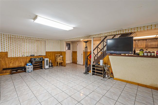 Finished basement featuring stairs, wallpapered walls, and a wainscoted wall | Image 20