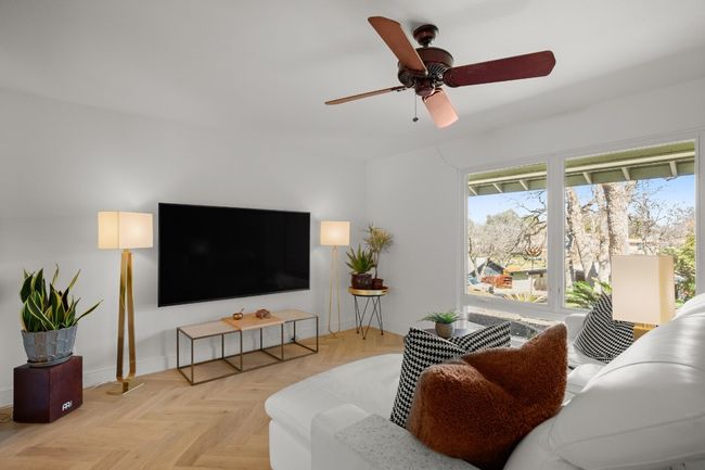 Living room with a ceiling fan and baseboards | Image 10