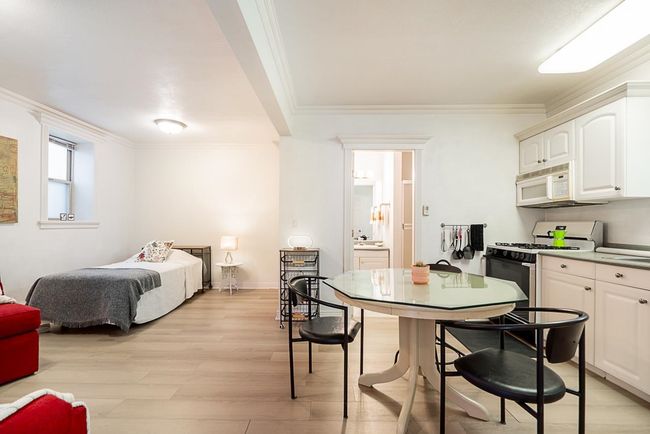 Bedroom with crown molding and light wood finished floors | Image 23