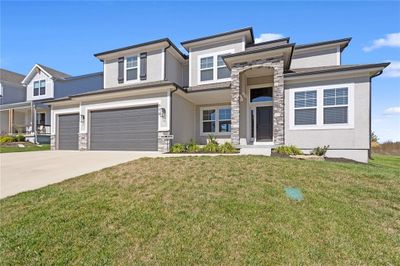 Prairie-style home featuring a garage and a front lawn | Image 2