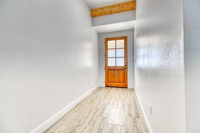 Doorway to outside with beam ceiling and light wood-type flooring | Image 3