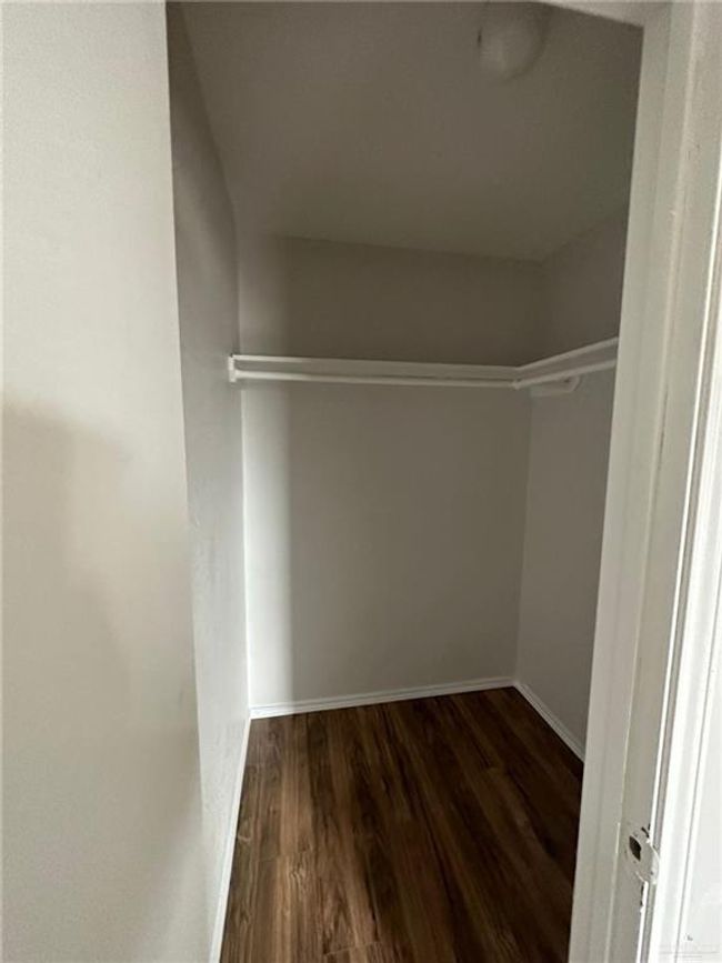 Spacious closet with wood finished floors | Image 16