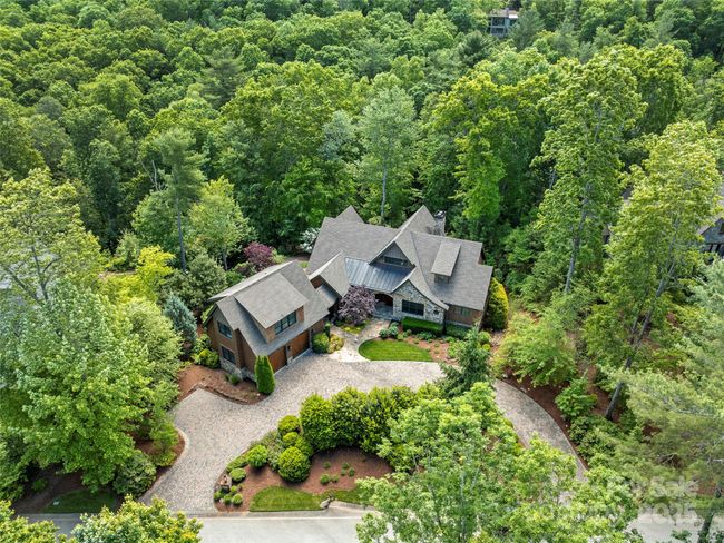 Aerial view of home and garage, circular drive with additional parking space to left of the garage. Private setting on one of Walnut Cove's most desirable streets. | Image 43