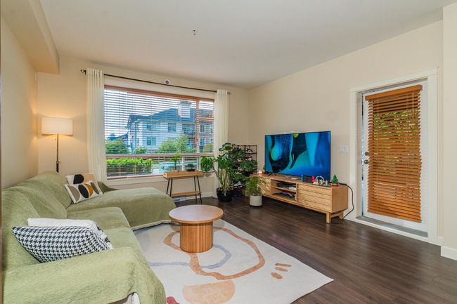 Living room with wood finished floors and baseboards | Image 9