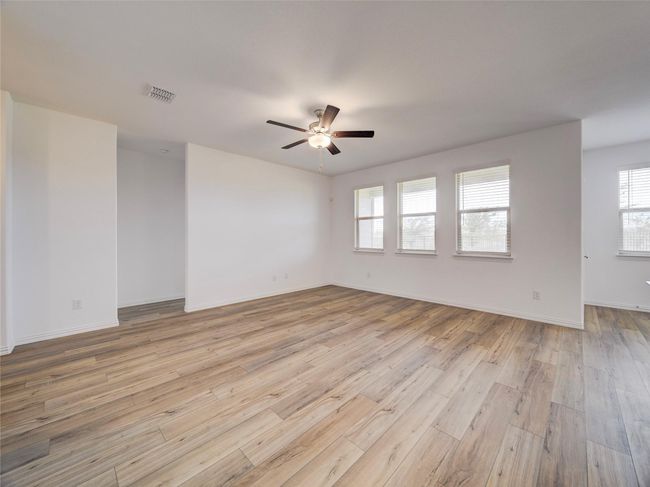 Empty room featuring light wood-style flooring, ceiling fan, and baseboards | Image 14