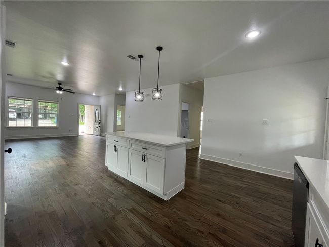 Kitchen with open floor plan, baseboards, dark wood-style floors, ceiling fan, and recessed lighting | Image 22