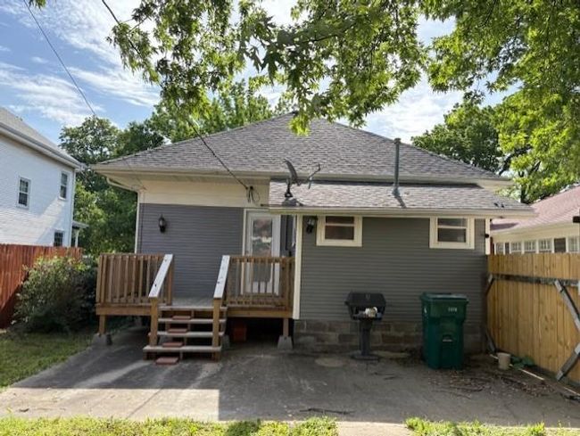 Back of house with fence, a wooden deck, and a shingled roof | Image 28
