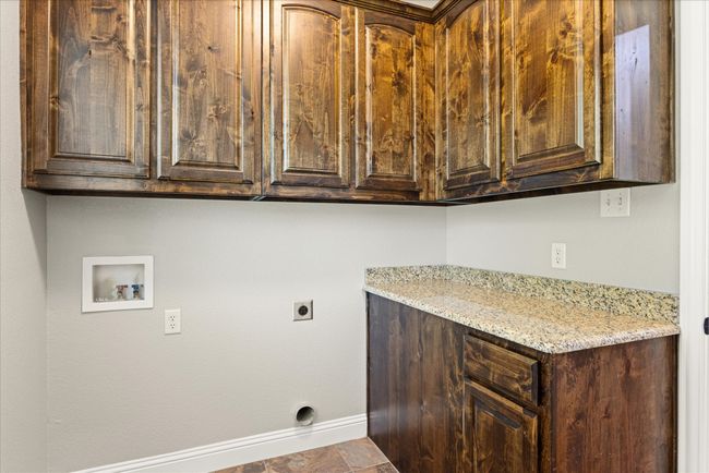 Washroom featuring cabinet space, electric dryer hookup, and hookup for a washing machine | Image 20
