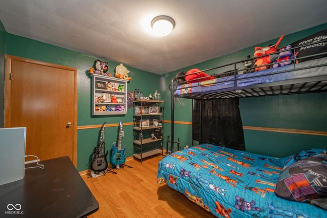 bedroom with wood finished floors | Image 14