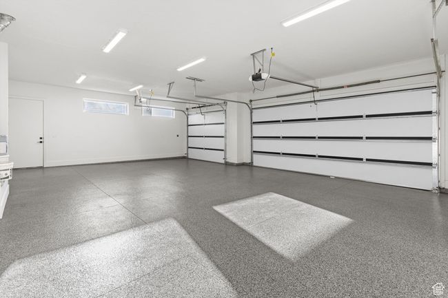 Garage with baseboards and a garage door opener | Image 27