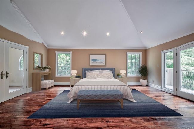 Bedroom featuring vaulted ceiling, access to outside, and multiple windows | Image 11