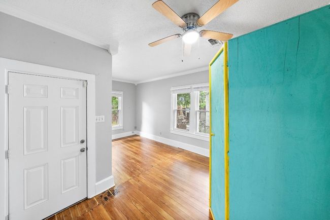 Entrance foyer featuring hardwood / wood-style floors, a ceiling fan, crown molding, and baseboards | Image 11