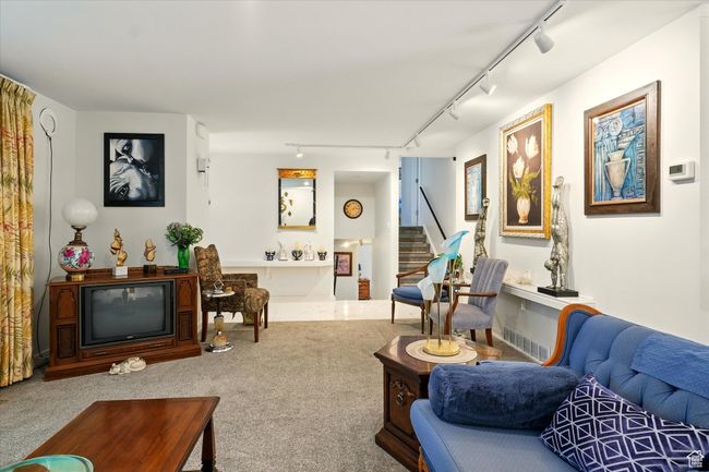 Living room with track lighting, stairs, and carpet flooring | Image 7