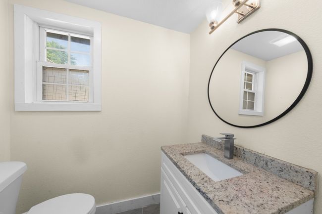 Half bathroom featuring toilet, vanity, and baseboards | Image 22