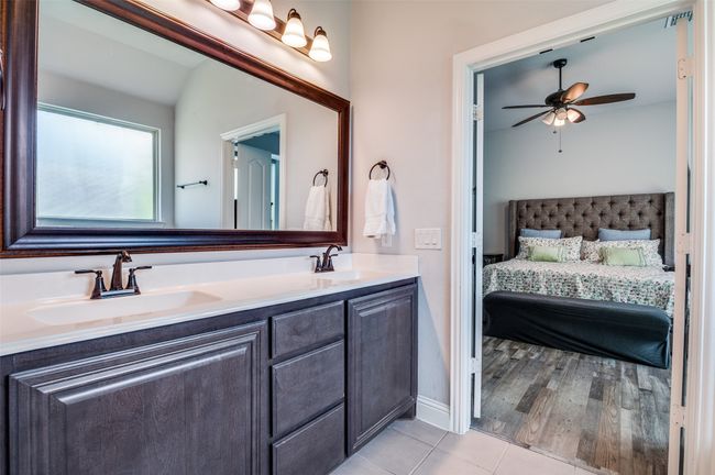 Bathroom featuring connected bathroom, double vanity, tile patterned flooring, and a ceiling fan | Image 17